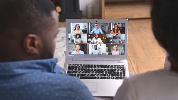 Multiracial Couple Using a Laptop for Video Call at Home