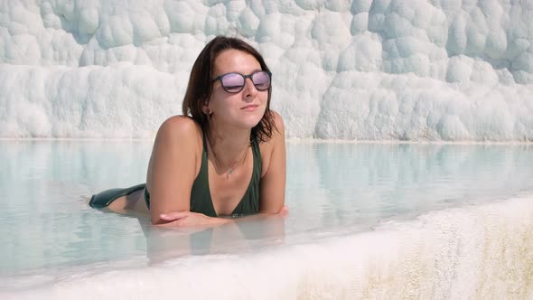 Woman in Sunglasses Bathing in Travertine Terraces Pools in Pamukkale, Turkey