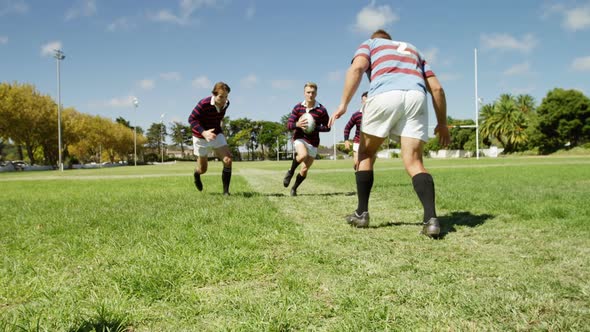 Rugby player running and holding ball 