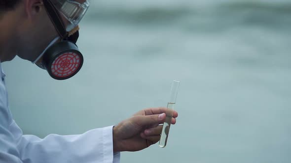 Closeup of researcher examining water pollution, risk of disease and death