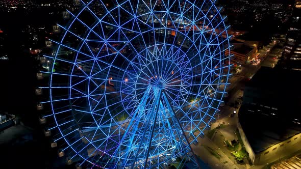 Night landscape of illuminated colorful ferris wheel at Rio de Janeiro Brazil