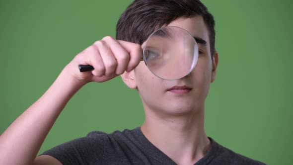 Young Handsome Iranian Teenage Boy Against Green Background