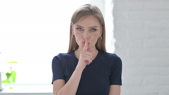 Woman Putting Fingers on Lips Quiet Sign