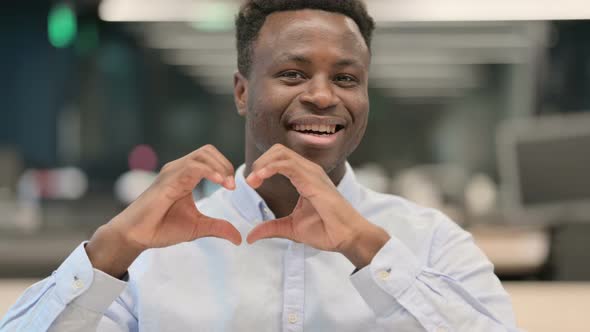 Portrait of African Businessman Showing Heart Sign By Hand
