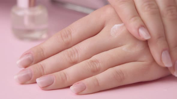 Woman Hand on Pink Makes Manicure for Herself