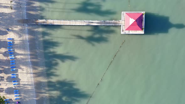 Overhead drone flight at a La Romana resort with jetty and gazebo; Caribbean