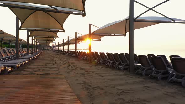 Beach Sunbeds and Umbrellas at Sunset.
