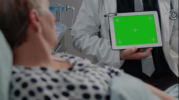 Close Up of Doctor with Horizontal Green Screen on Tablet