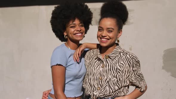 Front view of two mixed race women smiling