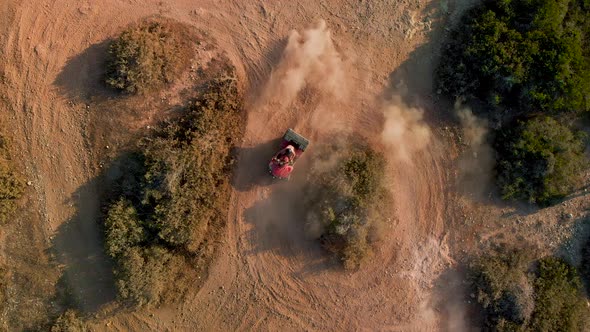 A single four wheeler dune buggy racing in circles on a dirt path at Cavo Greko