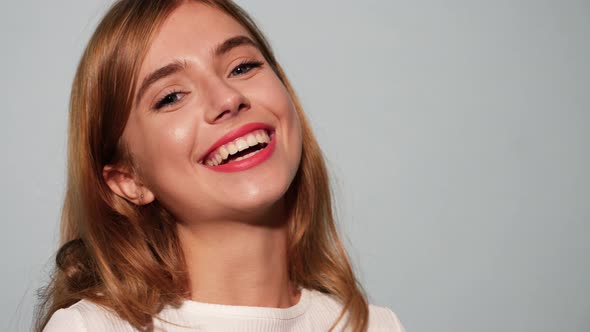 Young beautiful smiling woman looking at camera