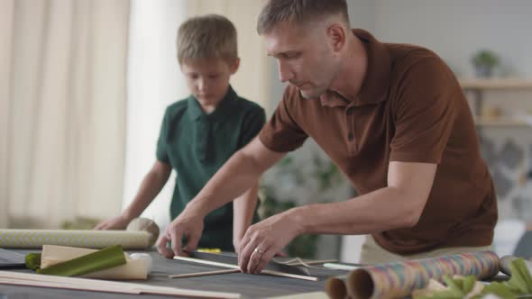 Father And Son Making Flying Kite