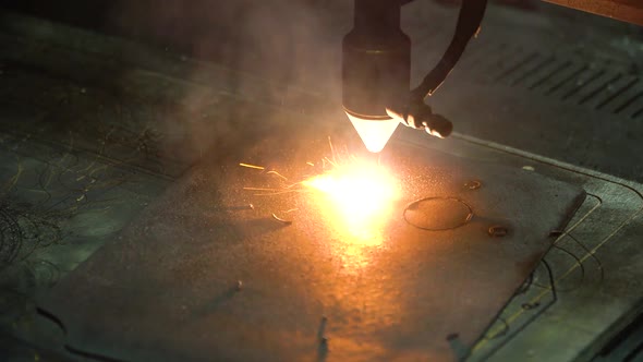 A Cnc Laser Machine Cuts a Part From a Piece of Steel