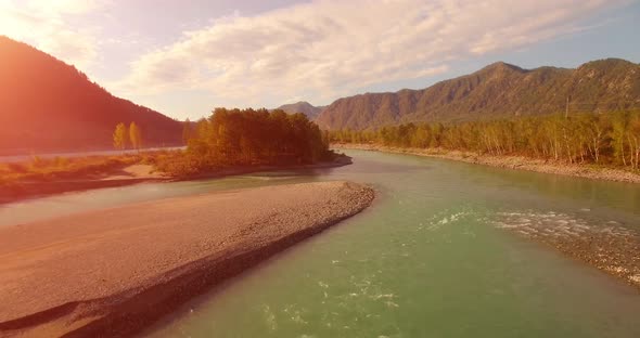 UHD Aerial View. Low Flight Over Fresh Cold Mountain River at Sunny Summer Morning. Green Trees and
