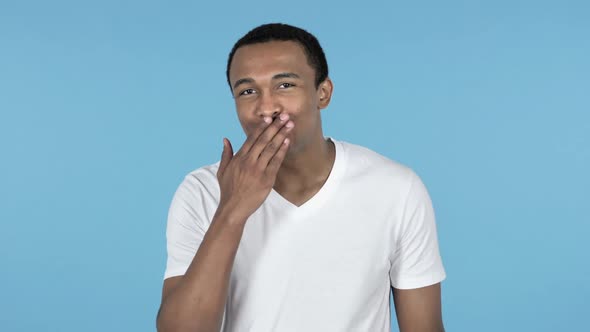 Flying Kiss By Young African Man Blue Background