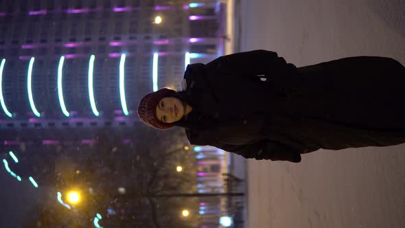 Attractive Woman Looking at Camera Night Walking on Street Snowfall Winter