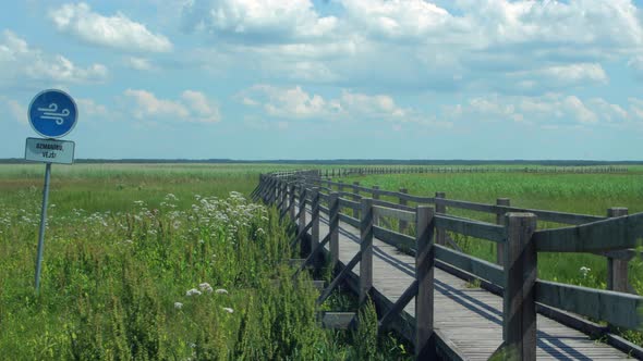 Time lapse of beautiful white fasting clouds and sky in sunny day at lake Liepaja footbridge path, "