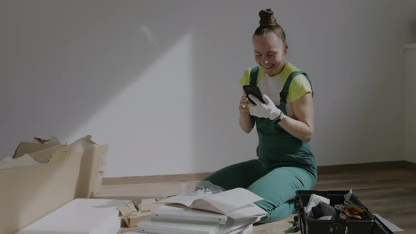 Young Female is Assembling a Piece of Furniture