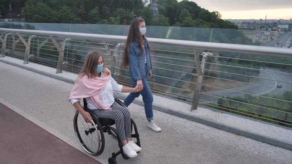 Disabled Mother with Girl in Masks Walking Outdoor