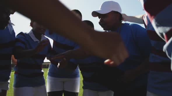 Young adult female rugby team and coach