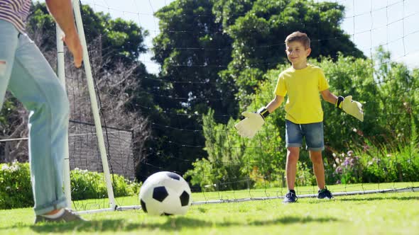 Father and son playing football