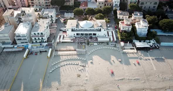 Top view of an hotel behind a sandy beach next to the Mediterranean. Genoa, Italy. aerial drone shot