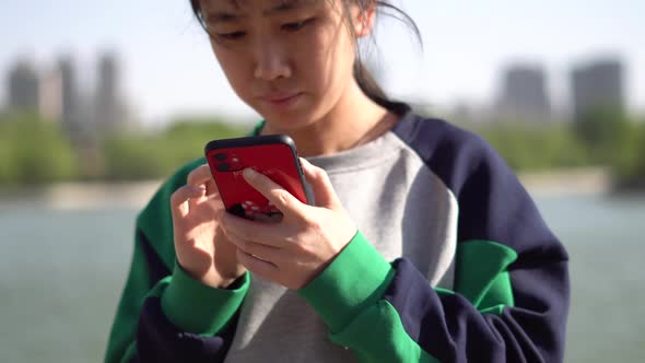 A Woman Playing Smart Phone Chatting And Typing