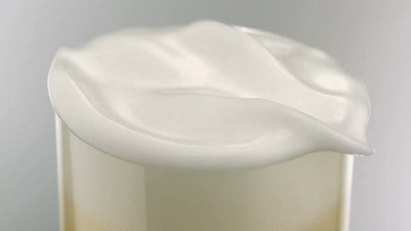 Overhead shot foam moving over beer glass, Slow Motion alt