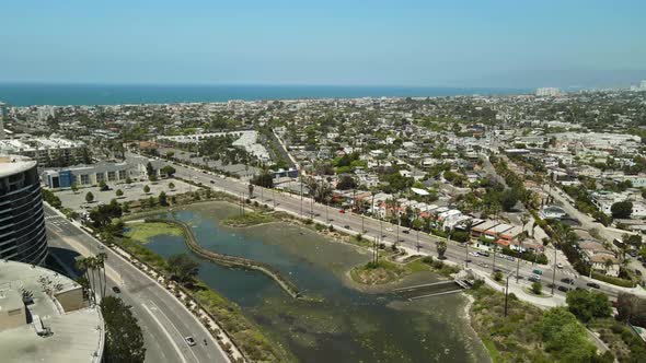 Aerial shot of buildings and roads near a California Beach