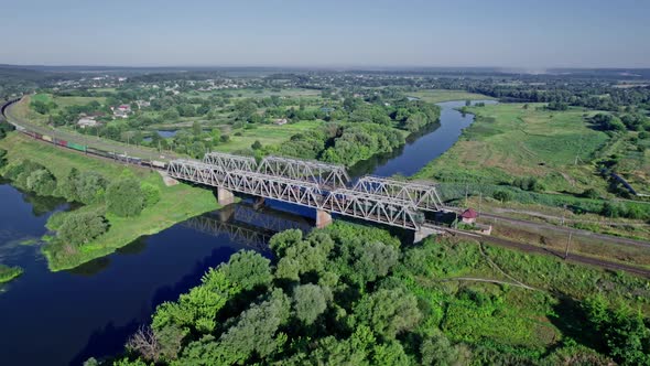 Train Bridge Crossing a River on a Bright Day