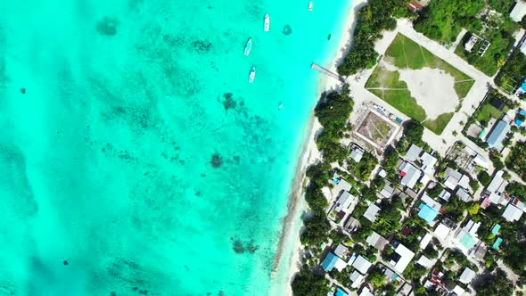 Aerial drone panorama of luxury coastline beach trip by blue ocean with white sandy background of a 