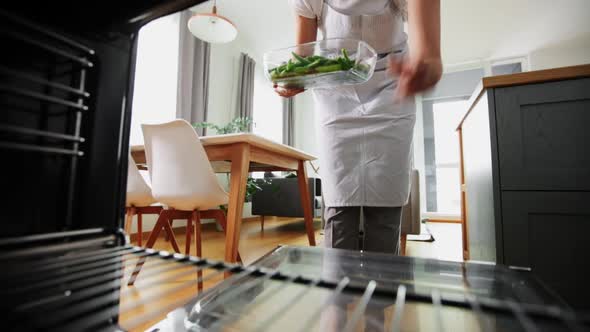 Woman Cooking Food in Oven at Home Kitchen