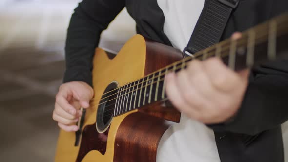 Close Up of Musician Playing Guitar in Underpass