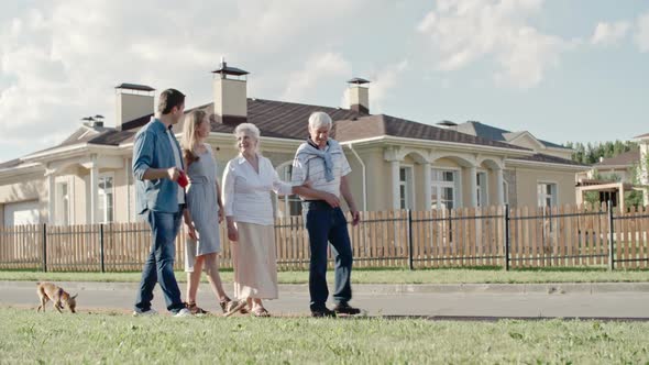 Young Family Walking with Elderly Couple