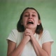 Hopeless Woman Screams and Cries with Fear Near Green Wall - VideoHive Item for Sale