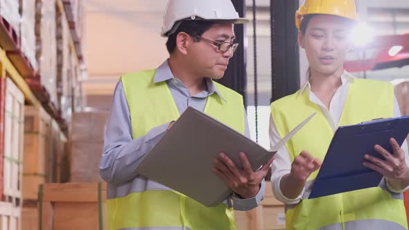 asian Male and Female Industrial Engineers in Hard Hats