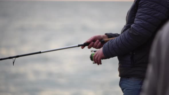 Man Hobby Fishing on Sea Tightens a Fishing Line Reel of Fish Summer