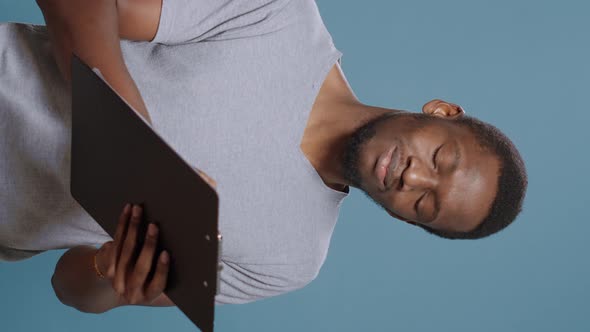 Vertical Video Financial Analyst Taking Notes on Clipboard Documents