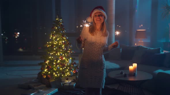 Woman Holding Sparklers and Dancing Near Christmas Tree