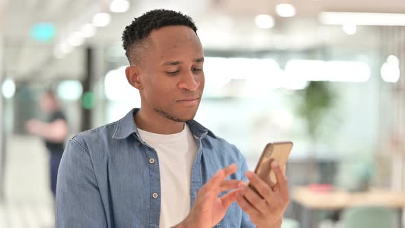 Portrait of Focused Casual African Man Using Smartphone 