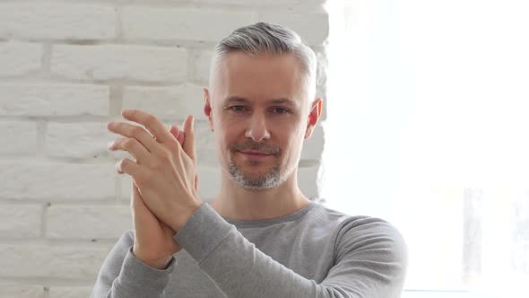 Applauding, Clapping Middle Aged Man Sitting in Office