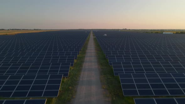 Aerial Drone View of Large Solar Panels at a Solar Farm at Bright Sunset in Early Winter