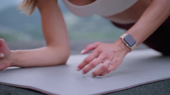 Woman is Practicing Fitness Outdoors Standing in Plank Closeup of Hands on Floor Mat