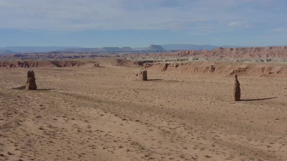 Drone shot flying towards some unique rock pillars in the Southern Utah desert