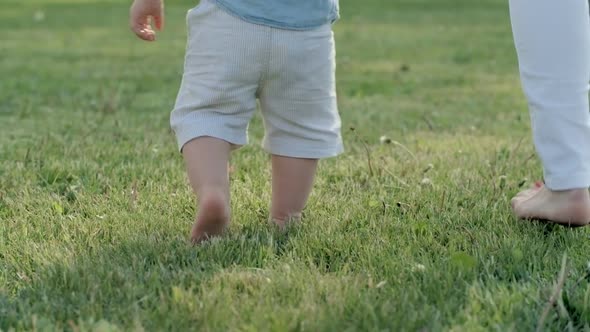 Mother and Toddler Walking Towards Lake