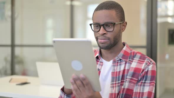 African Man Using Tablet Browsing Internet