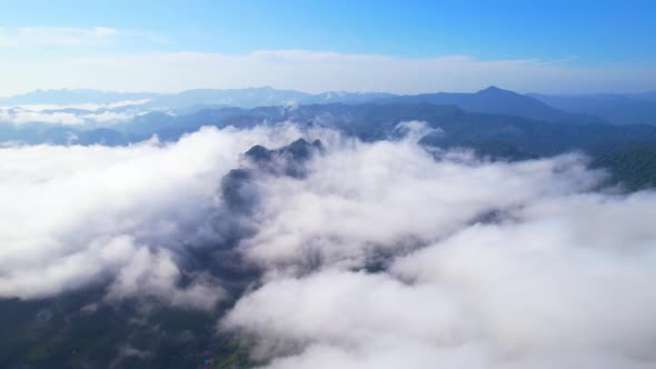 An aerial view from a drone flying over the many fogs in the mountains