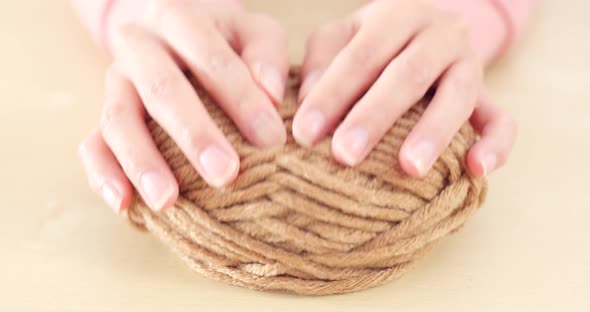 Woman hand holding knit wool ball