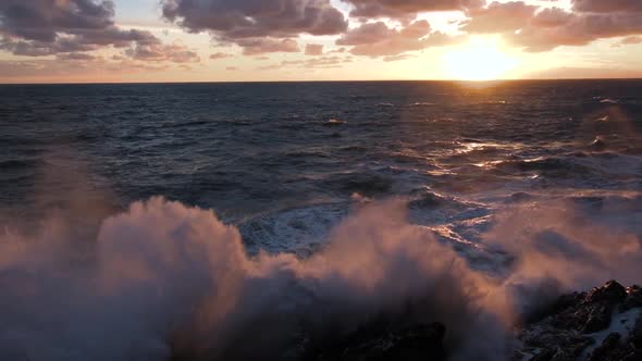 big waves during sunset in slow motion