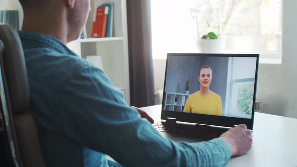 Young male entrepreneur works at home office at the computer.